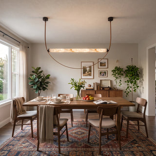 Altalena Leather Alabaster Pendant Light Vidirlighting Single Linear Alabaster Stone Cylinder Suspended by Cognac Brown Leather Straps with Matte Black Canopies over Dining Table