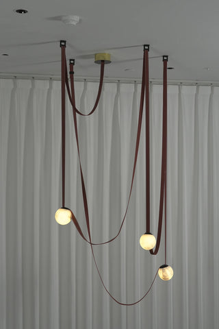 Anouk Draped Strap Alabaster Chandelier Vidirlighting Evening Lit Display Showing Glowing Translucent Stone Balls and Flowing Terracotta Fabric Straps