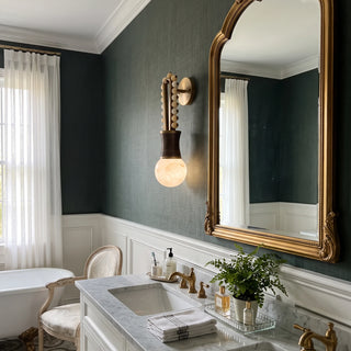 Ardora Beaded Alabaster Wall Sconce Vidirlighting Close-Up View beside Arched Brass Mirror and Marble Sink in Moody Powder Room