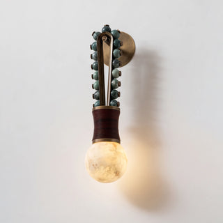 Ardora Beaded Alabaster Wall Sconce Vidirlighting Perspective Angled View Showing Lit Alabaster Sphere Casting Ambient Glow and Deep Wall Shadows