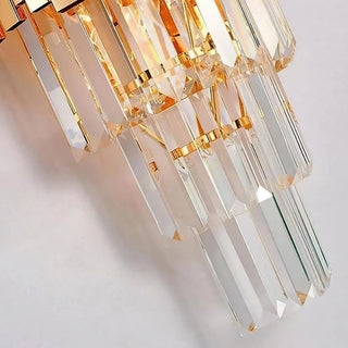 Macro detail of Bourbons Crystal Sconce K9 crystal rods, three cascading tiers of faceted clear crystals reflecting warm amber and rainbow light
