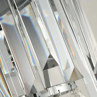 A close-up view of the transparent crystal rods on a wall lamp, where multiple elongated crystal columns refract rainbow-hued light, showcasing the optical quality and texture of premium K9 crystal.