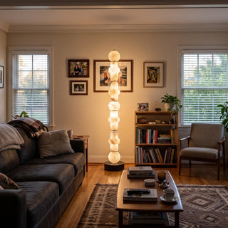 Cairn Alabaster Stacked Floor Lamp Vidirlighting Natural Stone Geometric Totem Standing Beside Linen Sectional Sofa and Glass Patio Doors in Living Room