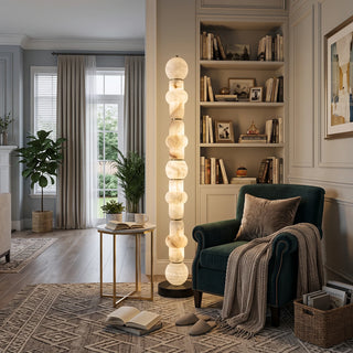 Cairn Alabaster Stacked Floor Lamp Vidirlighting Warm Glowing Organic Stone Pillar Lamp beside Emerald Green Velvet Armchair and Built-in Bookshelves