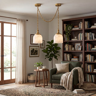 Carillon Chain Alabaster Bell Chandelier Vidirlighting Brushed Brass 2-Light Double Swag Chain Pendant above Green Armchair and Bookcase in Sunlit Reading Nook