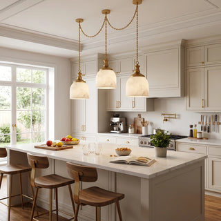 Carillon Chain Alabaster Bell Chandelier Vidirlighting Brushed Brass 3-Light Draped Chain Chandelier over Marble Breakfast Bar and Barstools