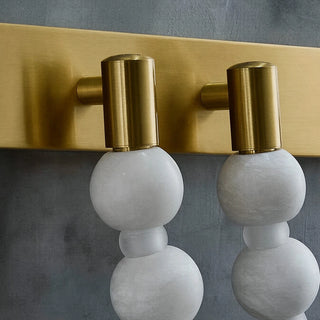 Collana Alabaster Bead Wall Sconce Vidirlighting Close-Up Detail of Brushed Brass Wall Plate and Solid Brass Suspension Hooks Supporting Stone Beads