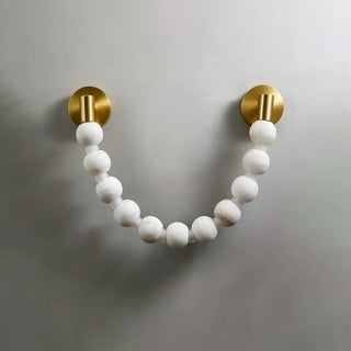 Collana Alabaster Bead Wall Sconce Vidirlighting Illuminated Single U-Shaped Alabaster Stone Beaded Sconce Casting Golden Halo on Dark Wall