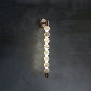 Collana Alabaster Bead Wall Sconce Vidirlighting Angled Perspective of Lit Double-Tier Beaded Wall Light Showing Projection Depth on Grey Wall
