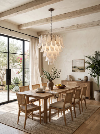 Cygnus Alabaster Feather Chandelier Vidirlighting Multi-Tier Translucent Stone Leaf Chandelier centered over Classic Wood Dining Table with Wall Art