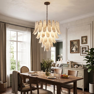 Cygnus Alabaster Feather Chandelier Vidirlighting Multi-Tier Translucent Stone Leaf Chandelier centered over Classic Wood Dining Table with Wall Art
