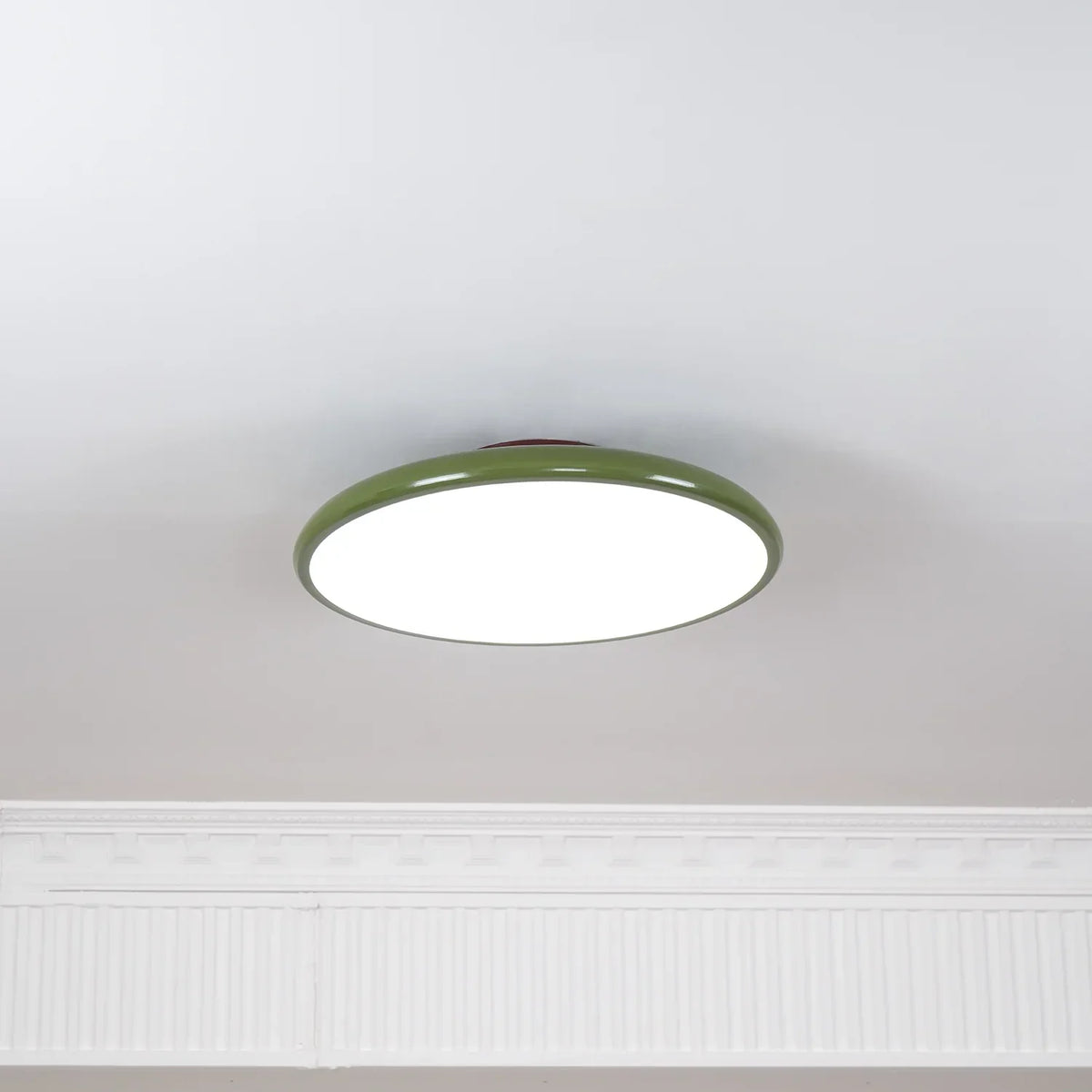 Slim disc ceiling light lighting a room with a low ceiling