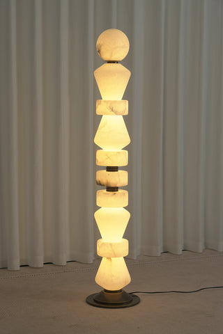 Geometric Alabaster Sculptural Floor Lamp Vidirlighting Illuminated Perspective View Showing Glowing Mineral Veining and Antique Bronze Spacer Rings in Evening Setting