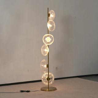 Glass Petals Floor Lamp Vidirlighting Lit Evening Scene Casting Warm Radiant Glow beside Single Armchair and Side Table in Living Room