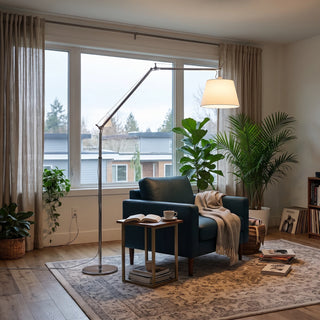 Gru Adjustable Arm Floor Lamp Vidirlighting Chrome Articulated Cantilever Reading Floor Lamp Arching over Teal Leather Armchair beside Large Window in Sunlit Living Room