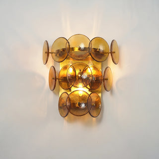 Lente Hammered Glass Disc Wall Sconce Vidirlighting Factory Sample Unlit Front View Showing Tiered Curved Amber Hammered Glass Discs on White Wall