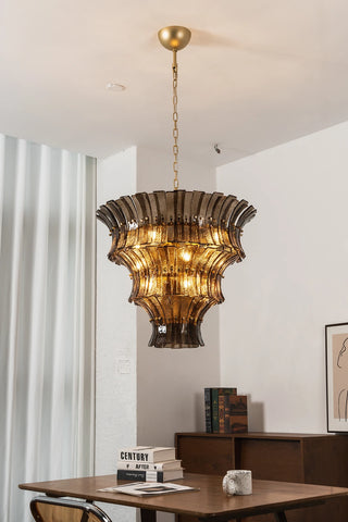 Lido amber smoke tiered chandelier illuminated over a modern dining table by Vidir Lighting