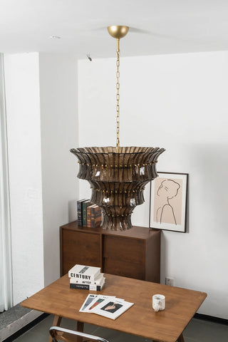 Illuminated Lido amber smoke glass chandelier in a bright contemporary dining room by Vidir Lighting