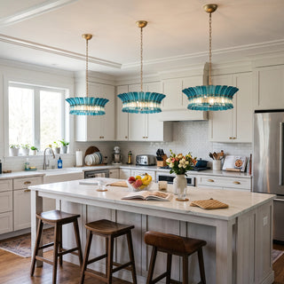 Trio of Lido blue textured glass pendant chandeliers over a kitchen island by Vidir Lighting