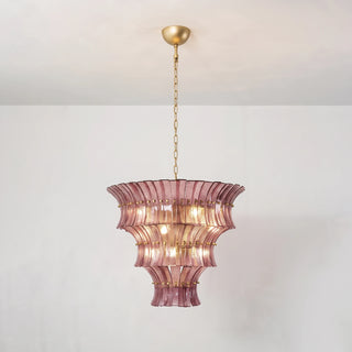 Glowing Lido amber smoke multi-tier glass chandelier hanging against white wall by Vidir Lighting