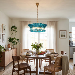 Lido ocean blue textured glass chandelier above a round dining table by Vidir Lighting