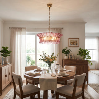 Lido rose pink textured glass chandelier illuminating a cozy dining space by Vidir Lighting