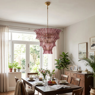 Lido rose pink tiered textured glass chandelier over a family dining table by Vidir Lighting