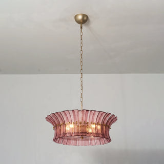 Lido multi-tier rose pink textured glass chandelier illuminated on white wall by Vidir Lighting