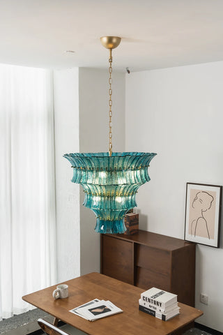 Lido single-tier teal blue textured glass chandelier glowing on white wall by Vidir Lighting
