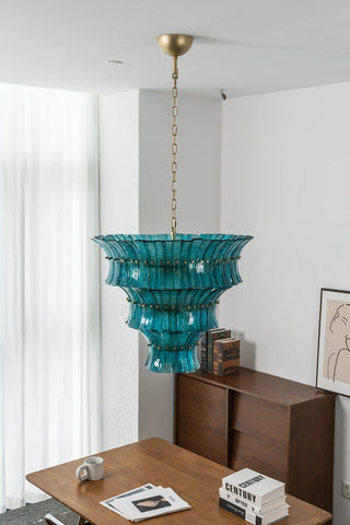 Lido teal blue tiered glass chandelier displayed in a bright modern interior by Vidir Lighting