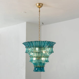 Front view of illuminated Lido teal blue tiered textured glass chandelier by Vidir Lighting