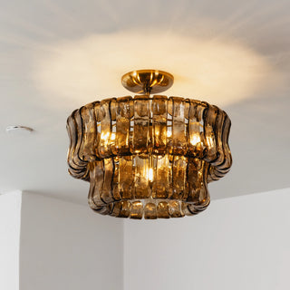 Nastro Textured Glass Ceiling Light Vidirlighting Low-Angle Illuminated Studio Shot Showing Warm Refraction through Layered Amber Glass Panels