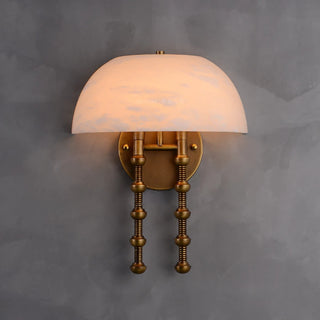 Ombrellino Alabaster Wall Sconce Vidirlighting Close-Up Lit Angle Featuring Translucent Alabaster Cloche Shade and Sculpted Bobbin Brass Stems