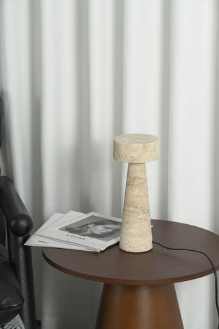 Travertine Kiwa Conical Table Lamp Vidirlighting Natural Beige Porous Stone Mushroom Silhouette Unlit Front View on Round Black Table with Power Cord