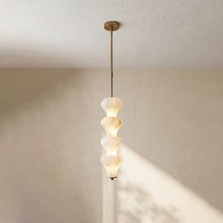 Trottola Alabaster Stacked Pendant Light Vidirlighting 4-Tier Brushed Brass Stem Stacked Alabaster Stone Pendant Fully Lit against Neutral Wall