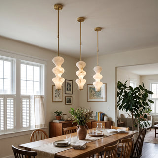 Trottola Alabaster Stacked Pendant Light Vidirlighting Elegant Trio of Warm Brass Stacked Alabaster Pendants Illuminating Large Open Kitchen Counter
