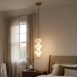 Trottola Alabaster Stacked Pendant Light Vidirlighting Three Warm Glowing Brass Alabaster Pendants Arranged in Line over Family Dining Table